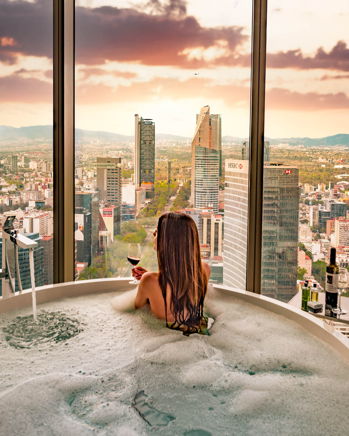 girl sitting in a bathtub and overlooking Mexico City