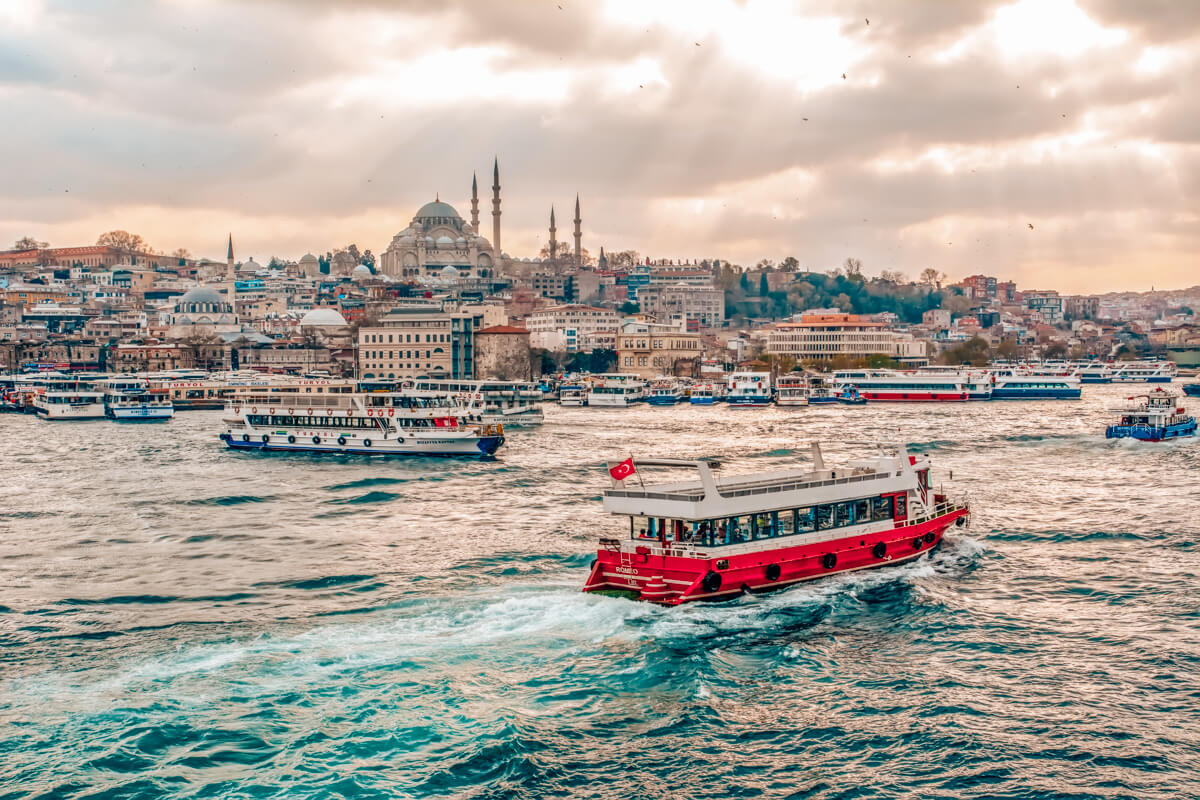 a ferry on the Bosphorus river in Istanbul with the blue mosque in the background