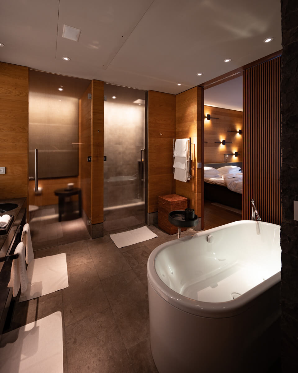 the huge and cozy bathroom of our deluxe room at The Chedi Andermatt with a freestanding bathtub