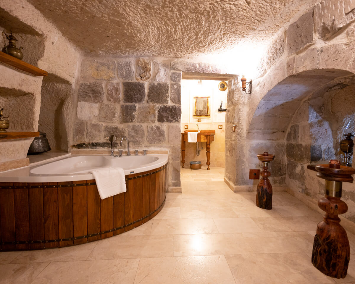 bathroom with bathtub in a cave suite of the Koza Cave Hotel in Cappadocia