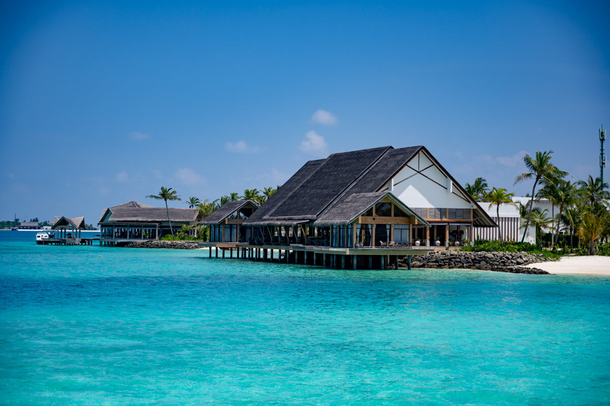 Restaurant over the turquoise water at the Hilton Maldives Amingiri