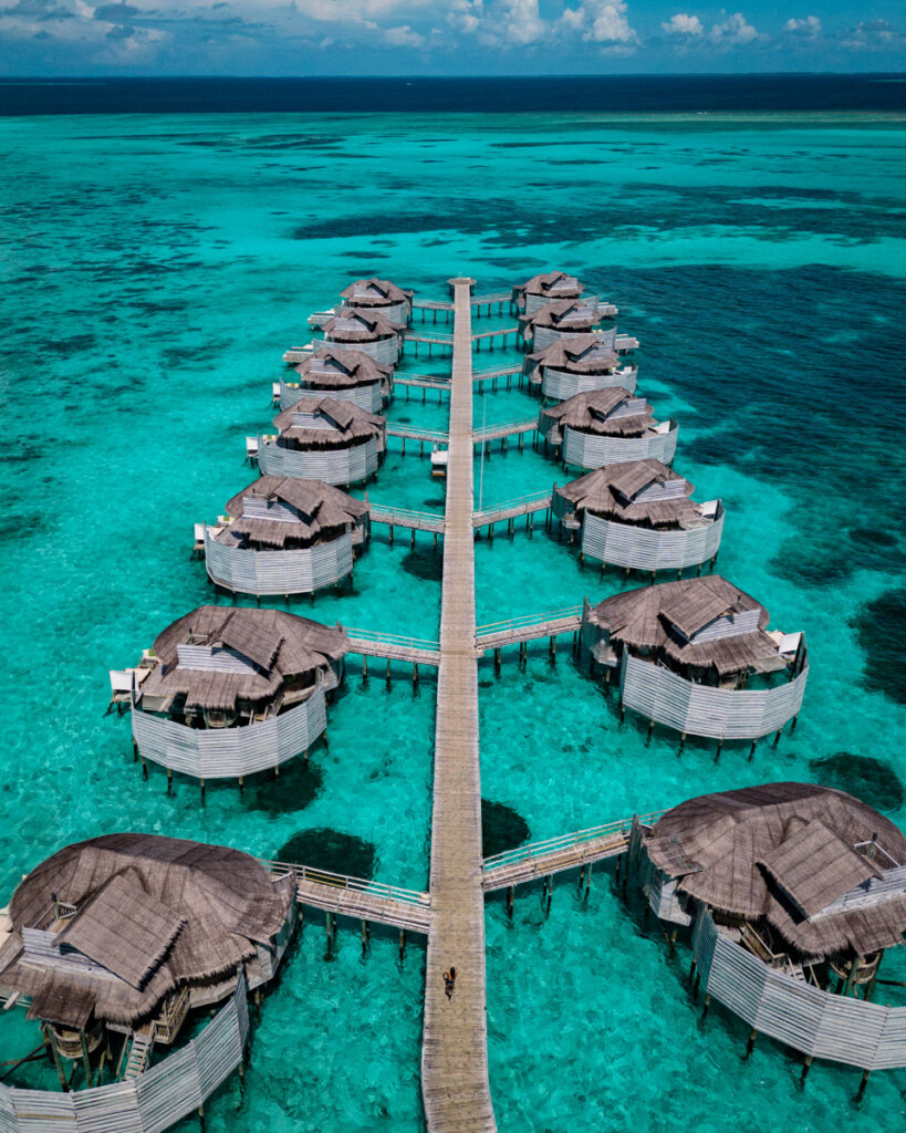 hotel Review of the Six Senses Laamu Maldives, drone photo of the over water bungalows in blue water
