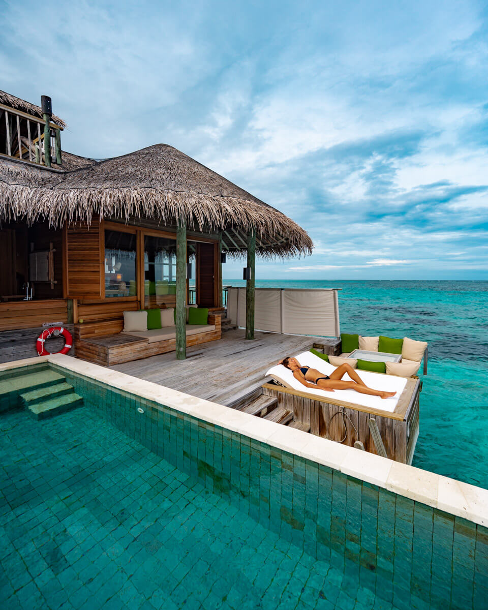 terrace of the water villa at the Six Senses Laamu Maldives with pool and sun beds