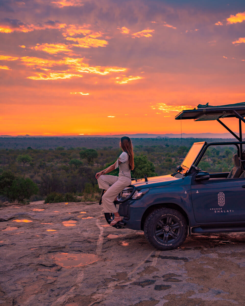 sitting on a safari car in the Kruger national park in South Africa and overlooking the sunset over the savannah