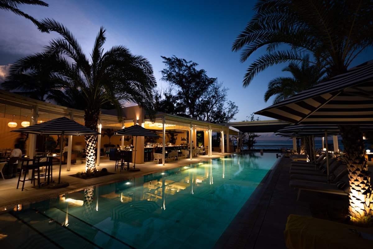 night shot of a pool and restaurant at the SALT of Palmar Boutique Hotel in Mauritius