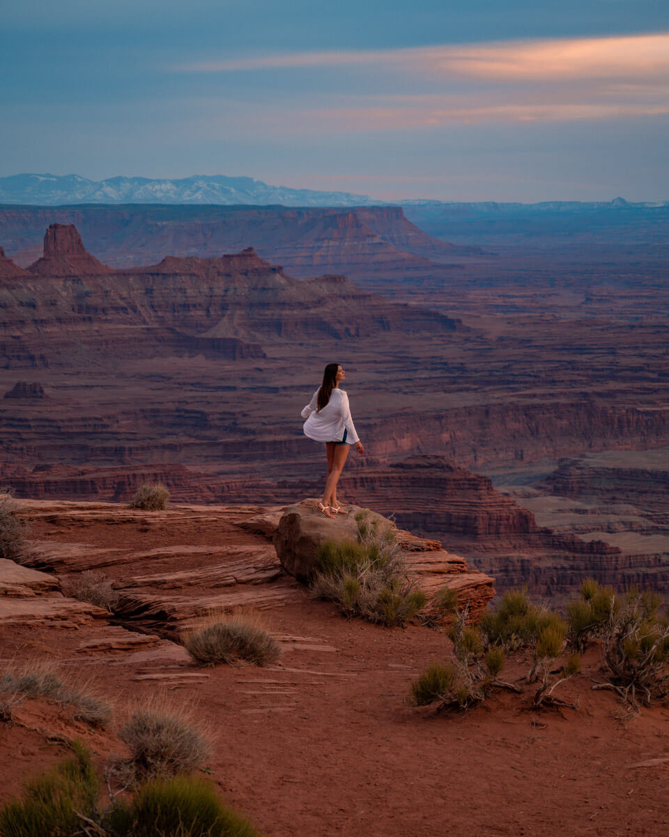 girl watching the view from the dead horse view point in Utah during sunset