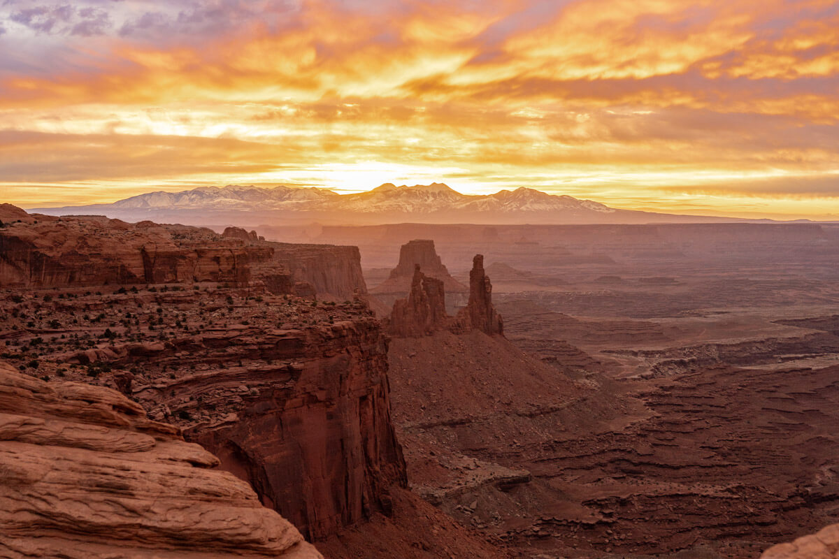 overlooking the sunrise and the beautiful landscape of caynonlands national park in Utah