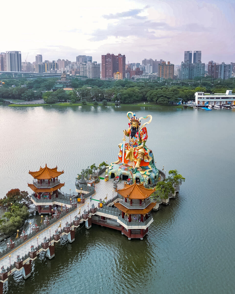 overlooking the lotus pond in Kaohsiung with a colorful statue in the water