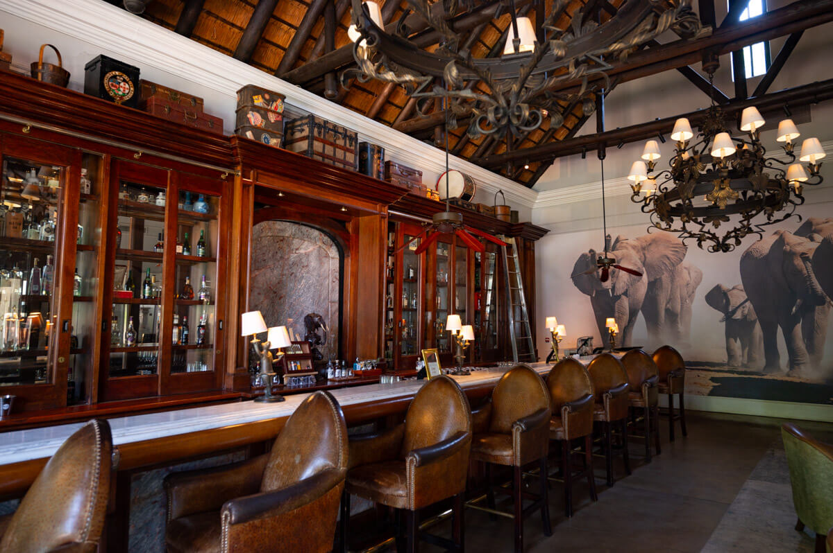the elegant bar with leather chairs and 20's interior design at the Royal Livingstone Hotel in Zambia