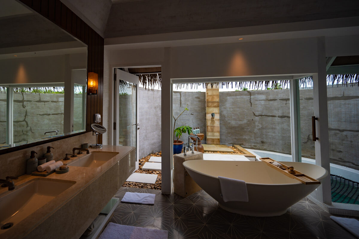 the open bathroom of a water villa at the Six Senses Kanuhura in the Maldives