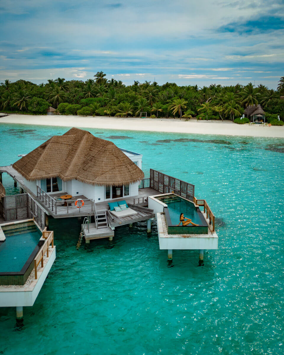 a water villa at the Six Senses Kanuhura in the Maldives with the island in the background