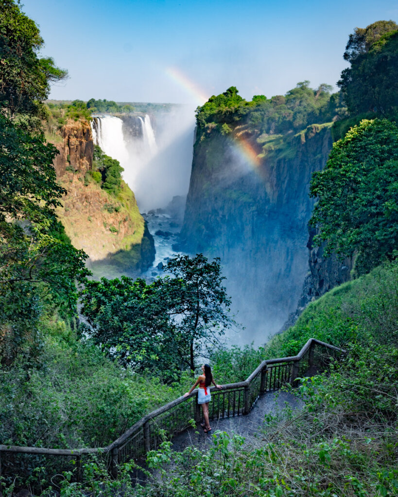 overlooking the Victoria Falls from a lookout in the Victoria falls national park in Zimbabwe with a rainbow