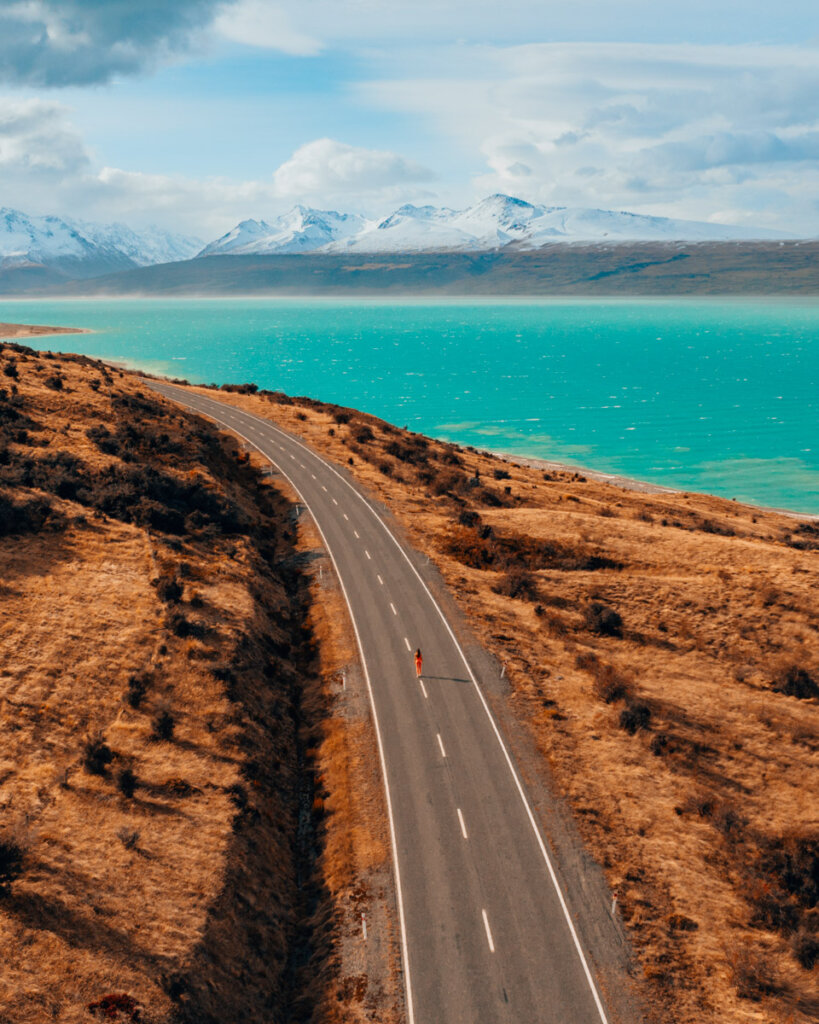 The road leading to Mount Cook National Park, next to the Tasman Lake with blue water