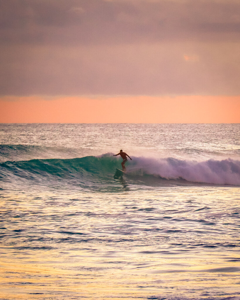 Surfer at Oahus North Shore at the Sunset Beach Point