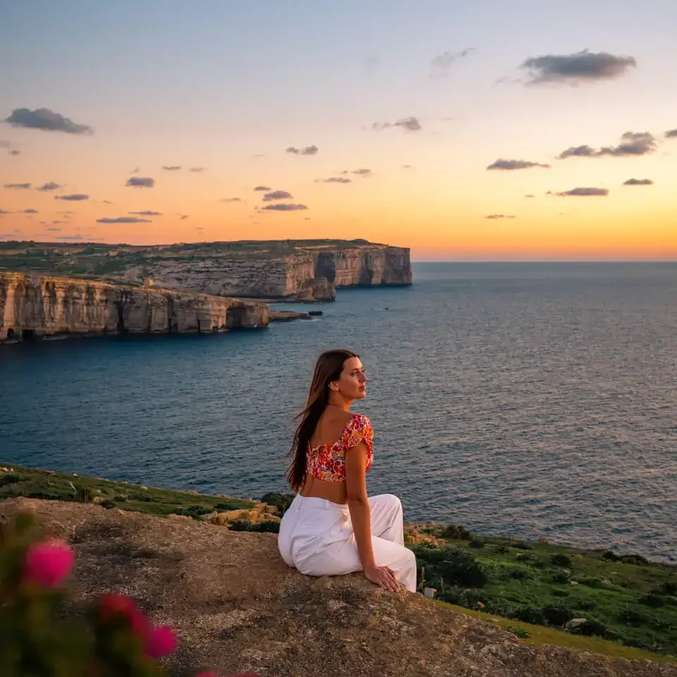 gozo-island-malta-sights sitting at the coast line of Gozo and enjoying the sunset