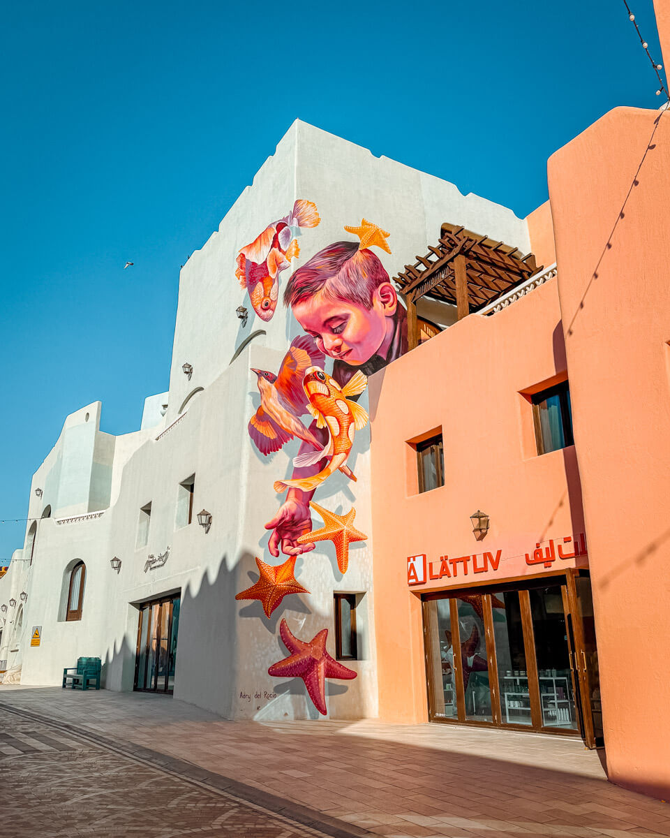 colorful building with wall art at the Mina District in Doha, Qatar