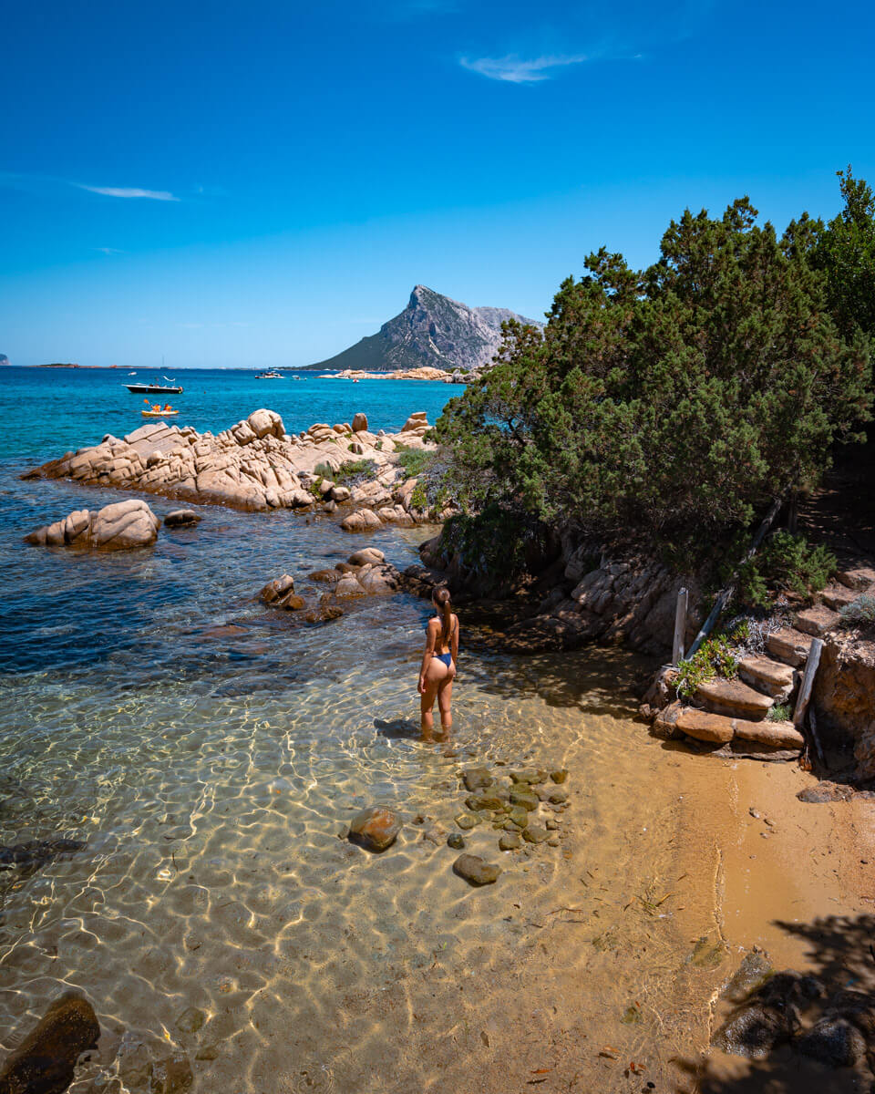 walking in the blue water at a beach in Sardinia, Italy