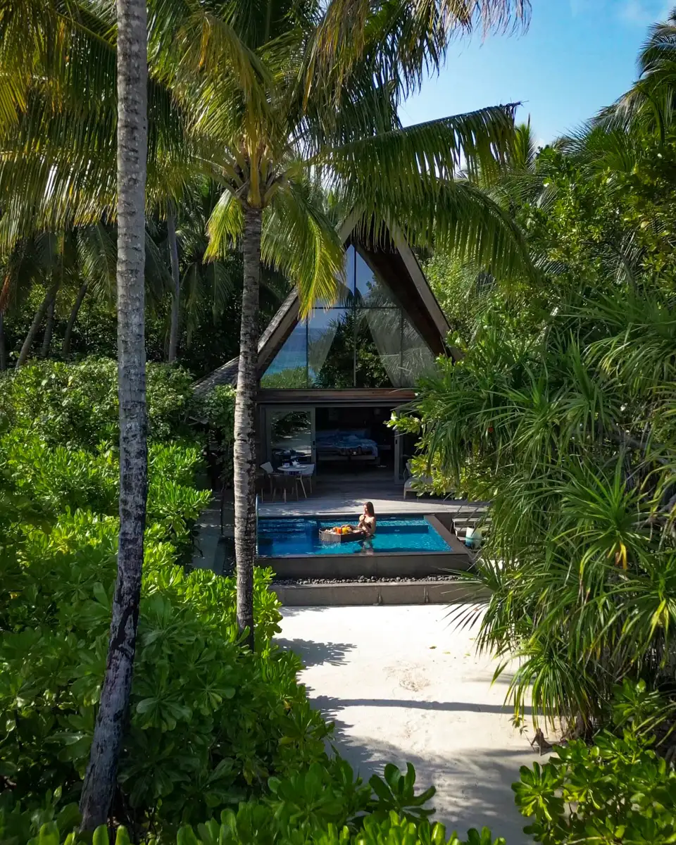 St. Regis Maldives Vommuli Resort, Beach Villa with Pool surrounded by green palm trees