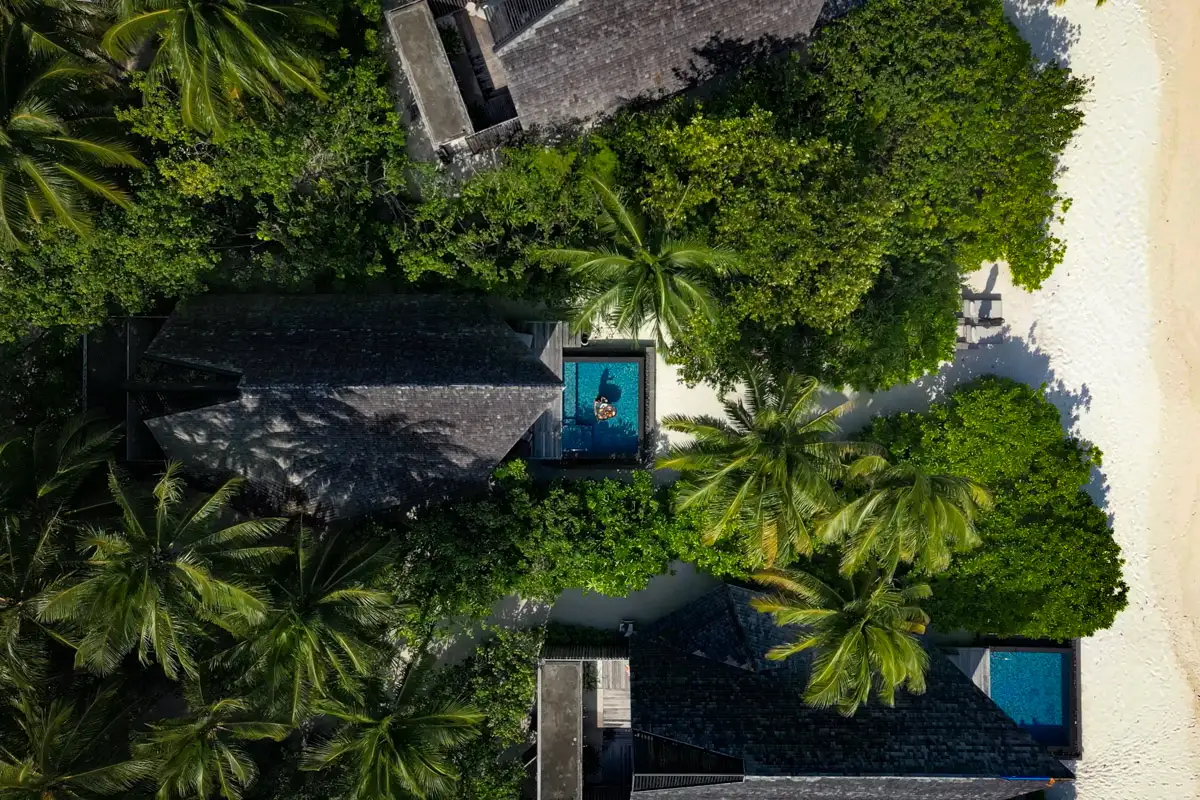 St. Regis Maldives Vommuli Resort, Beach Villa with Pool surrounded by green palm trees