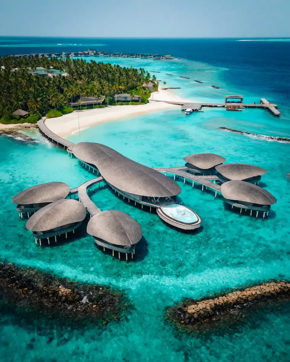 Lobster shaped spa at the St. Regis Maldives seen from above, over water spa surrounded by blue water