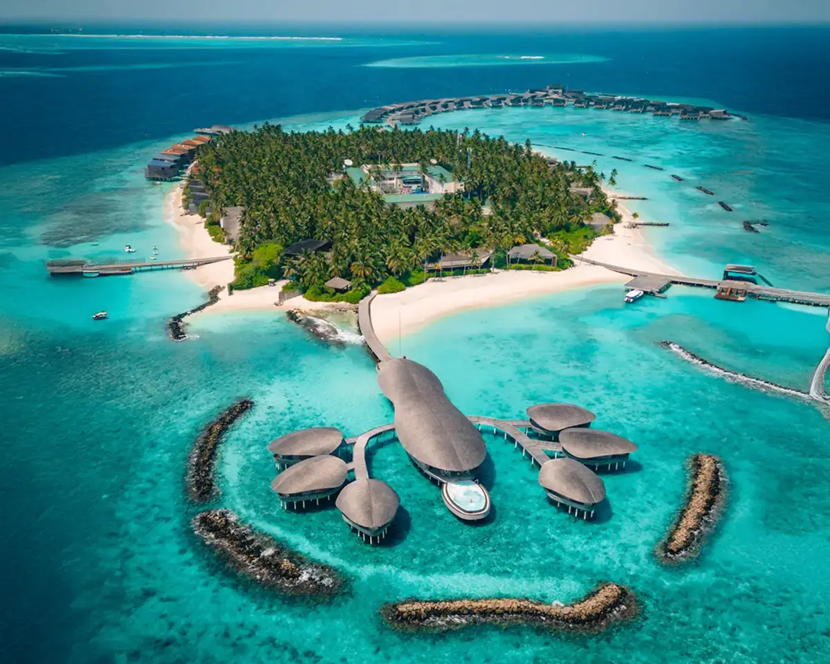 Lobster shaped spa at the St. Regis Maldives seen from above, over water spa surrounded by blue water