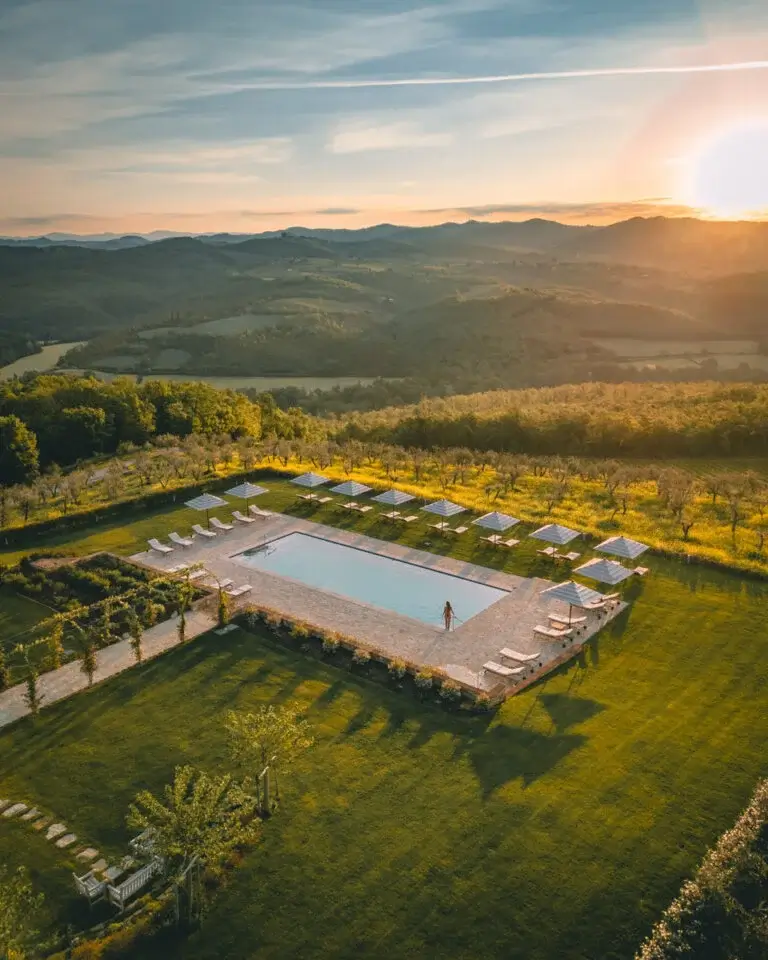 a pool between green hills in Tuscany, one of the best travel destinations in Italy