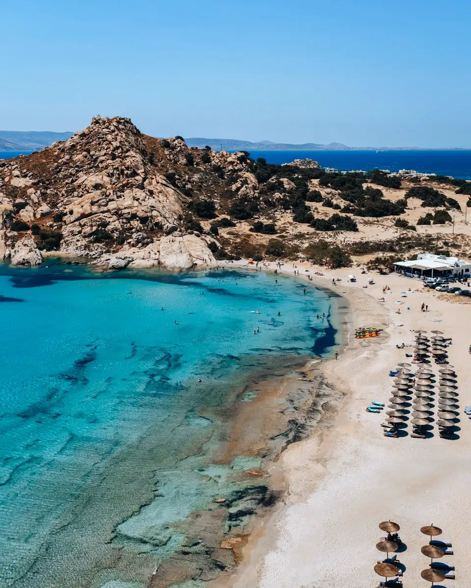 beach tip on Naxos island in greece: Mikri Vigla sandy beach, family friendly with beach chairs and blue water