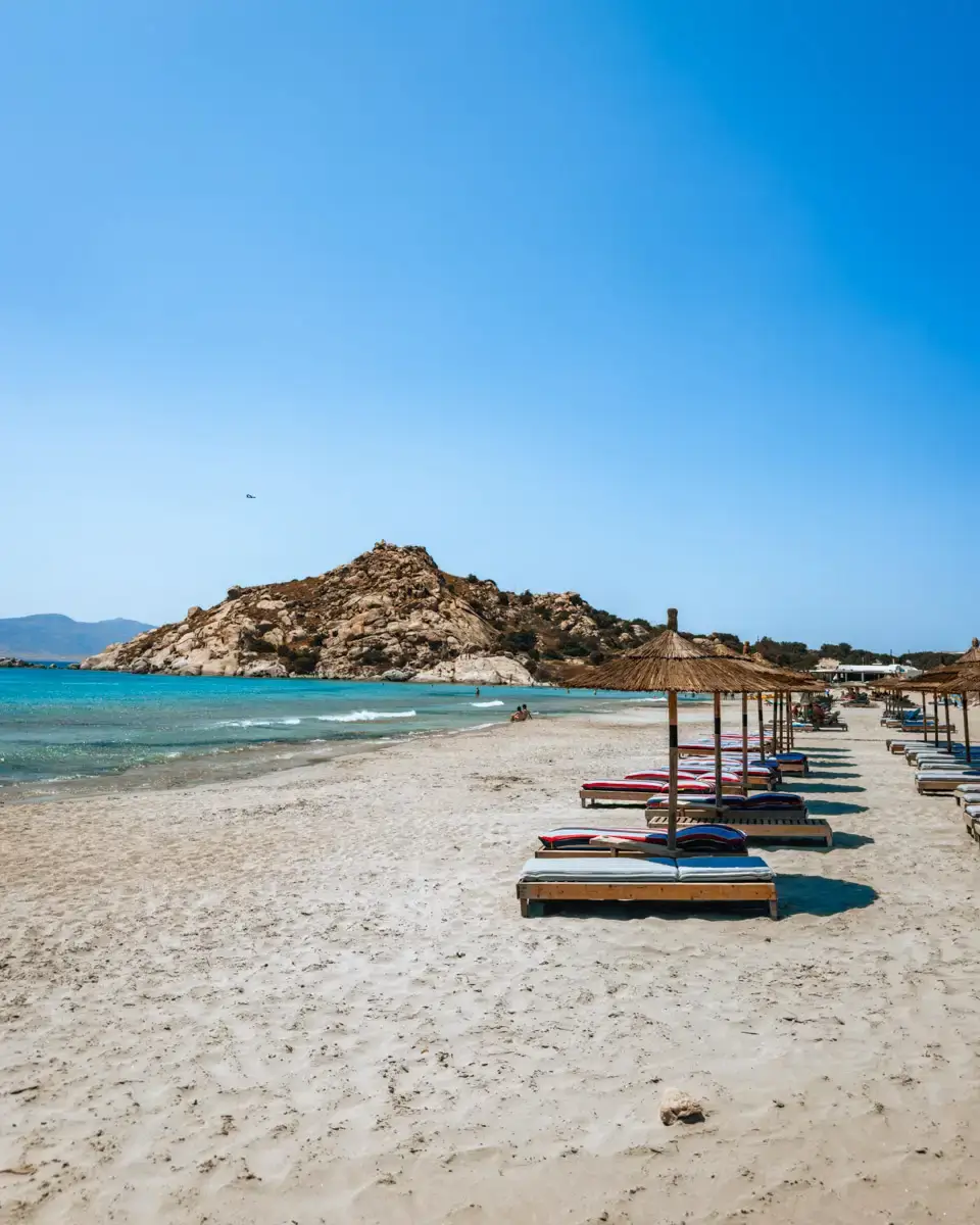 beach tip on Naxos island in greece: Mikri Vigla sandy beach, family friendly with beach chairs and blue water