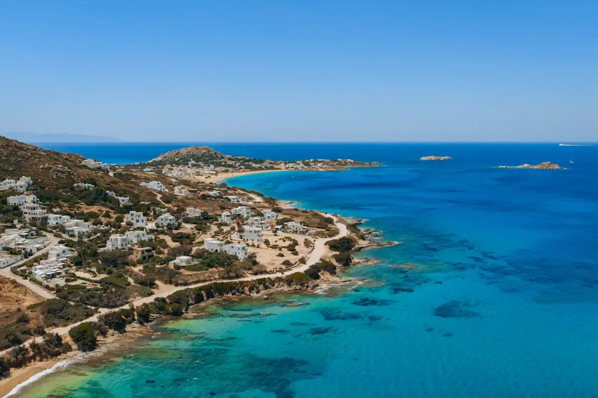 aerial view over Naxos island in Greece, with blue water and white picturesque houses