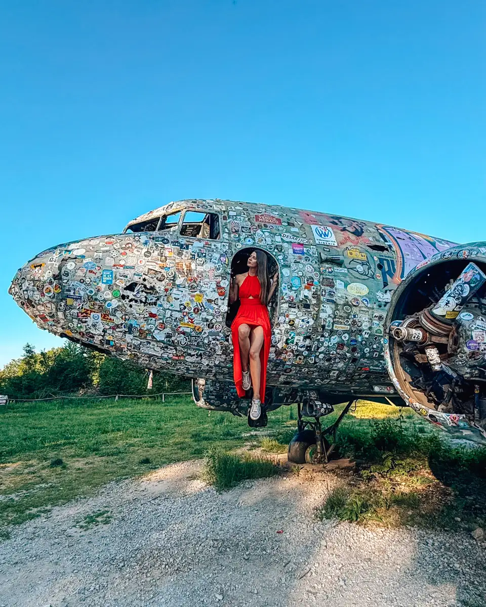sitting at the edge of the plane wreckage at the