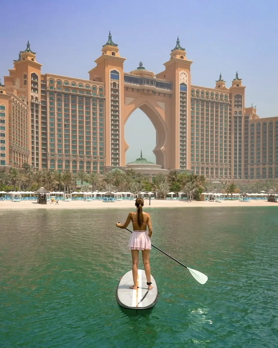 stand up paddle boarding in front of the Atlantis The Palm hotel in Dubai